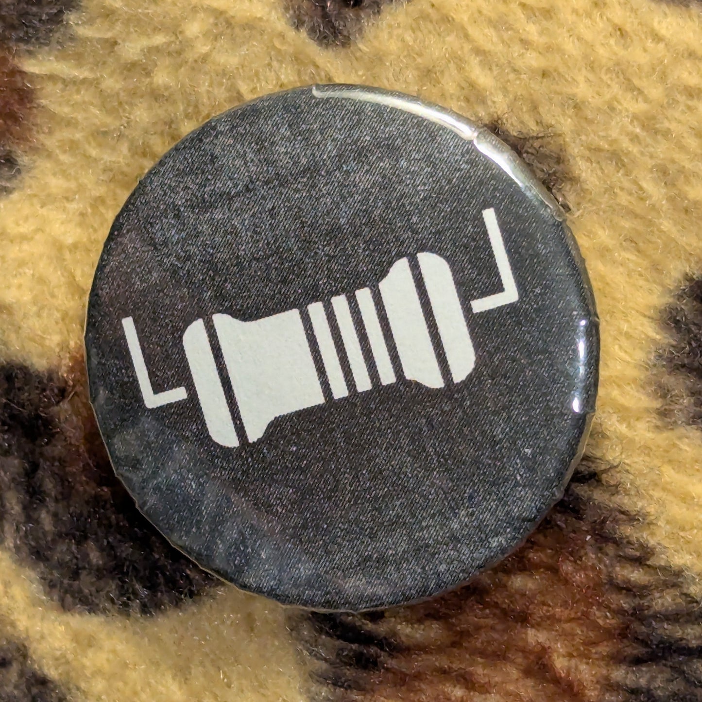 Button with a design on a leopard print background